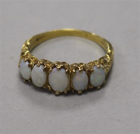 A 9ct gold and graduated five stone white opal ring, size T.